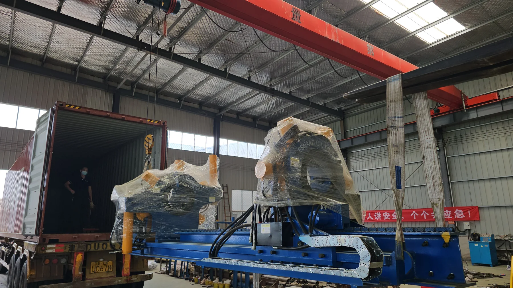 What Is Upstream Oil and Gas, and Where Do Its Threaded Connections Get Made Up? 2 Wrapped GALIP bucking unit lifted beside an open container at the factory