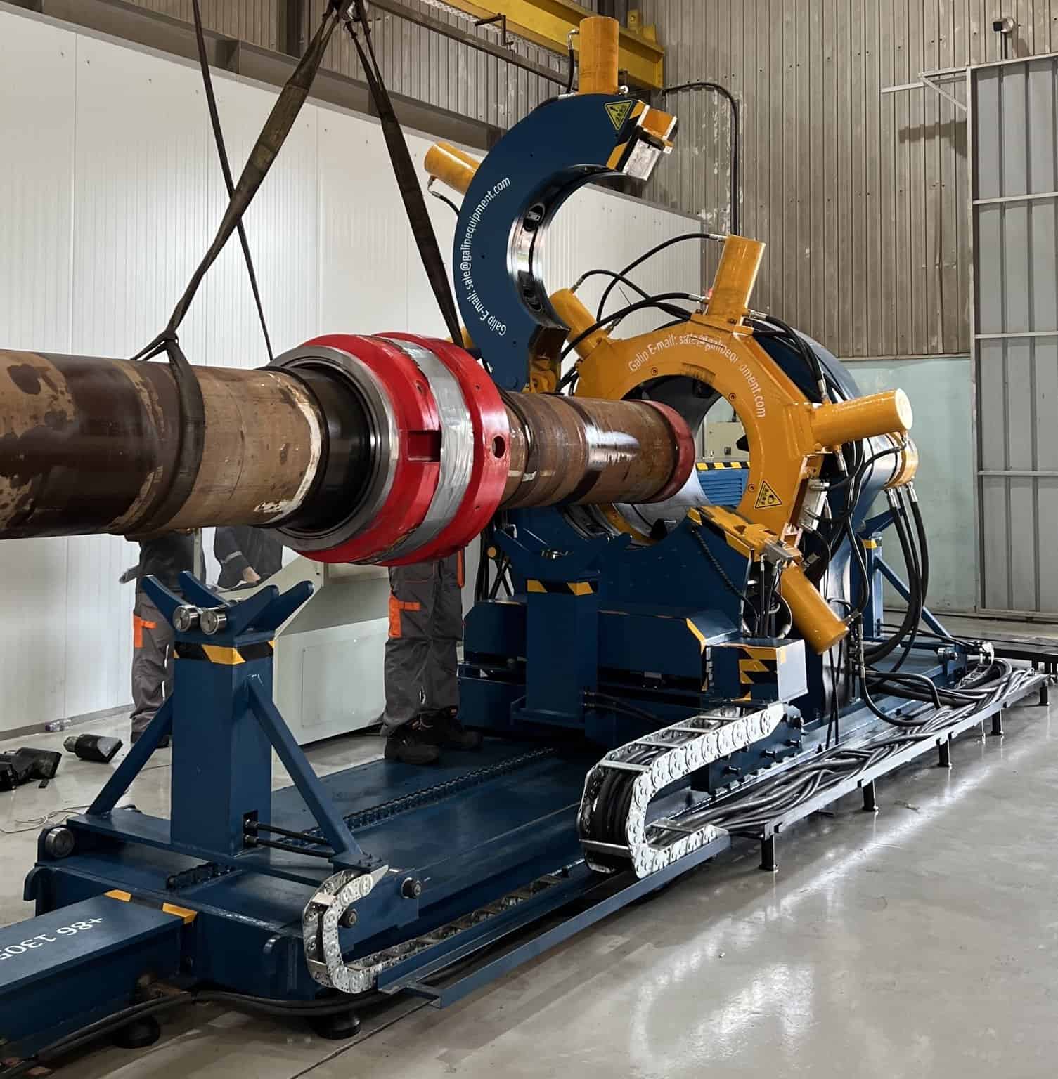 Directional Drilling: How a Well Is Steered, and Which of Its Tools Are Made Up Before the Rig 1 Operator at a hydraulic bucking unit making up a threaded downhole tool connection in a workshop