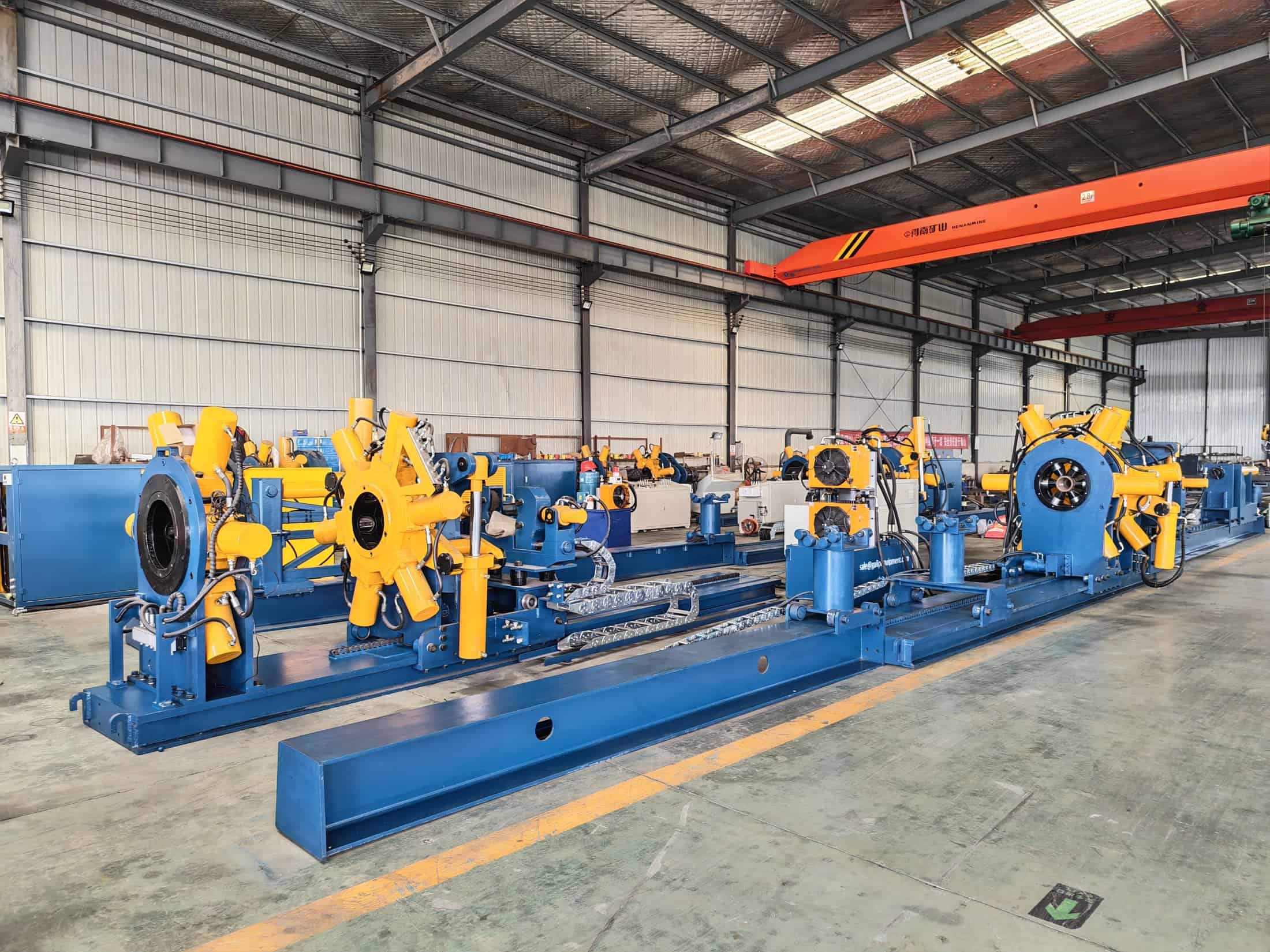 Shale Completion Workshop Make-Up: How Bucking Units Handle High-Volume Jobs 2 Row of Galip hydraulic bucking units arranged on the production floor for repeated high-volume make-up work
