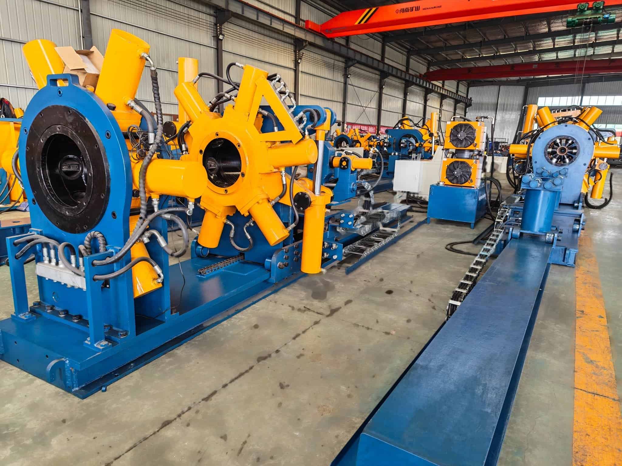 Midstream Oil and Gas: Where Line Pipe Is Welded, and Where It Is Still Threaded 2 Side view of the yellow clamp head of a GALIP hydraulic bucking unit