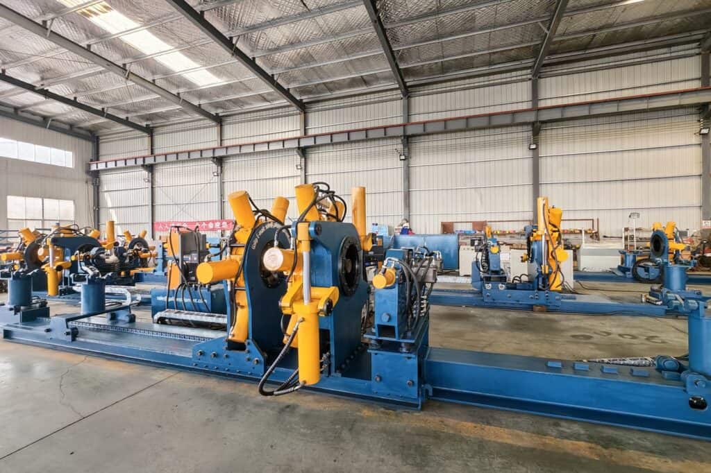 Oilfield drilling equipment with torque and casing handling tools in factory.