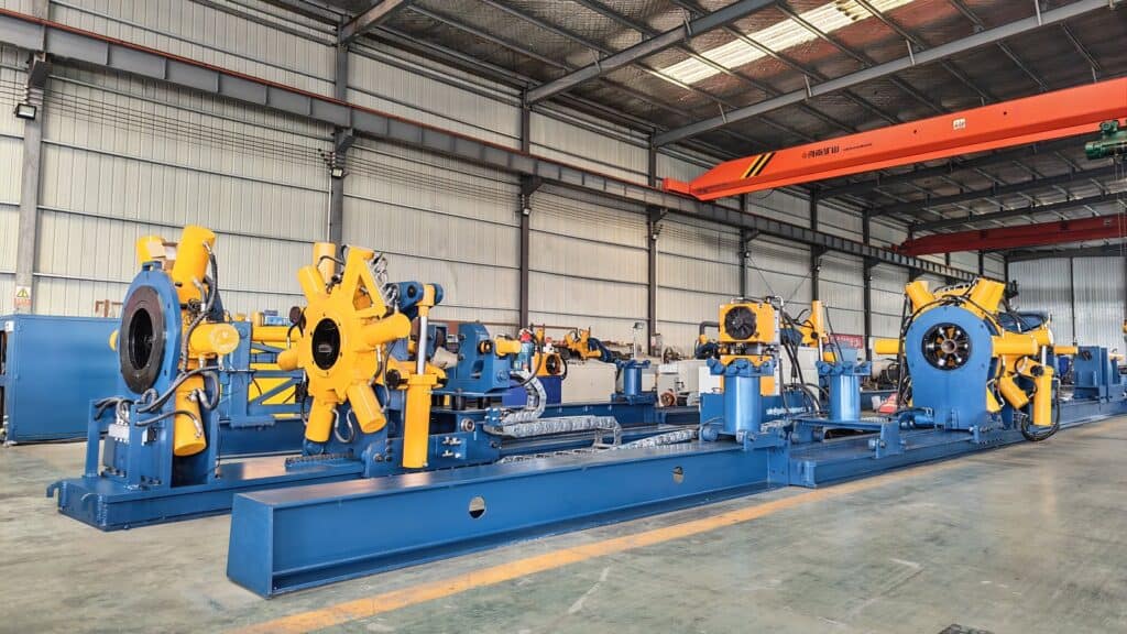 Large oilfield equipment manufacturing line with drilling motors and torque tools.