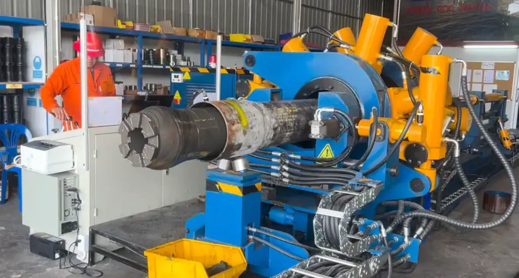 Galip 15-inch breakout unit breaking out a large downhole tool in the customer's workshop, operator at the control console