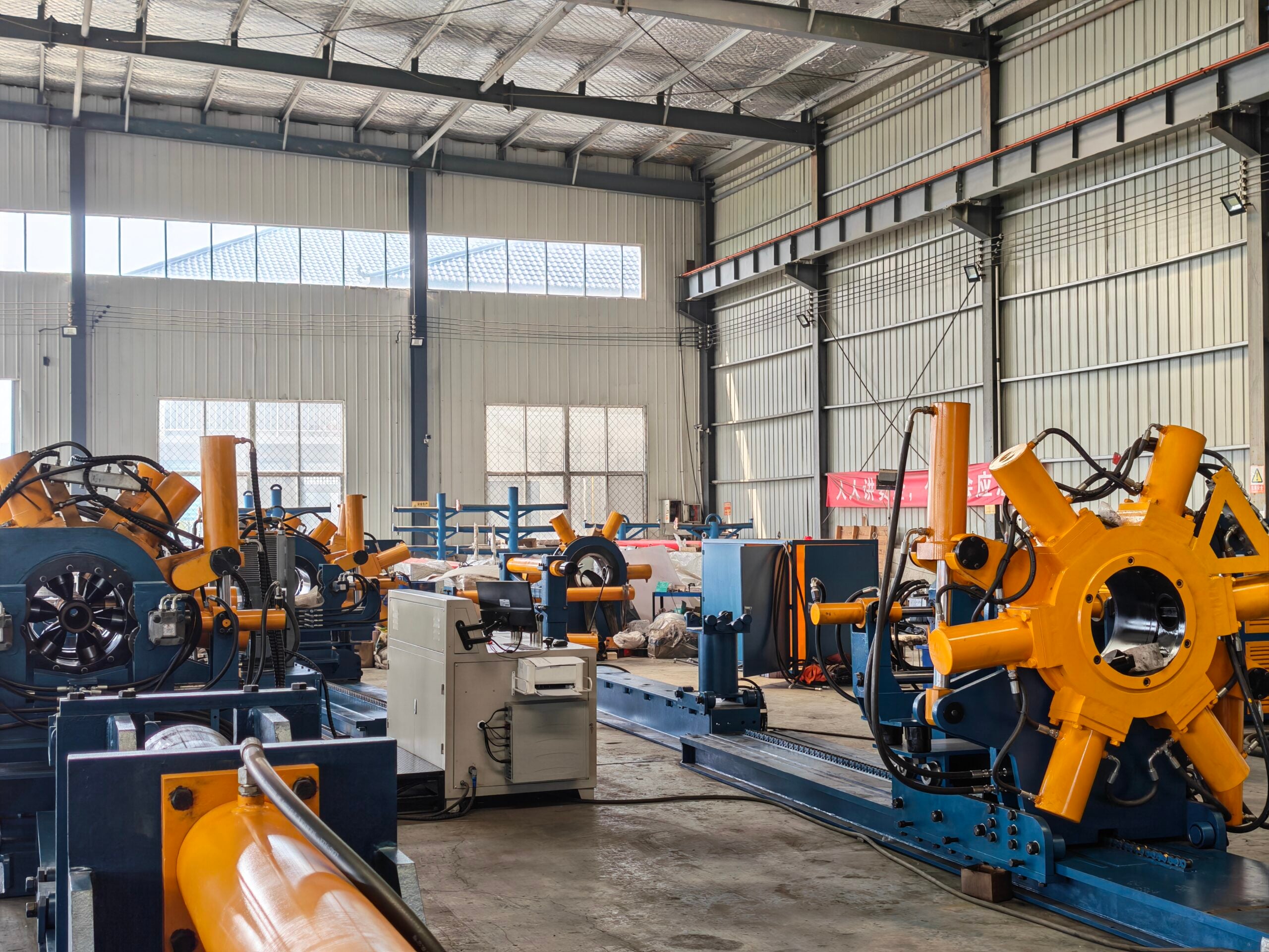 The Wellhead in Oil and Gas: Its Components, the Christmas Tree, and Where Threads Meet Flanges 2 Row of GALIP hydraulic bucking units on the factory floor with workshop windows behind them