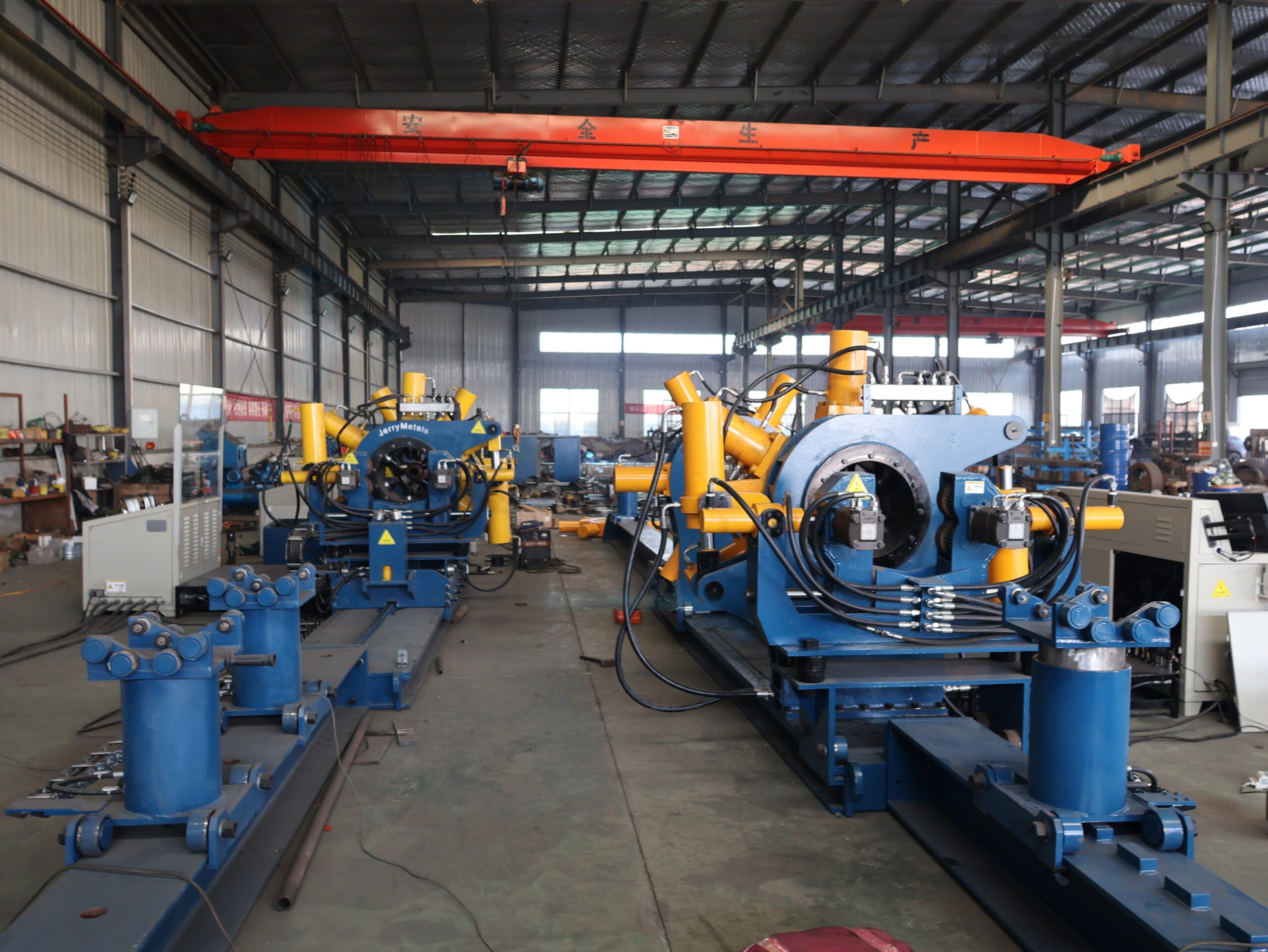 Downstream Oil and Gas: Why Torque Control Moves From Threads to Flanges 1 Wide view of a workshop with GALIP bucking units under an overhead crane